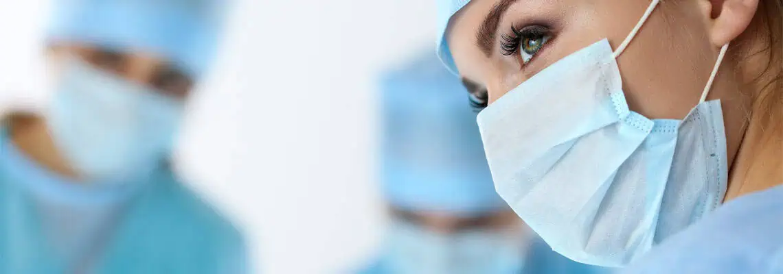 Three,Surgeons,At,Work,Operating,In,Surgical,Theatre,Saving,Patient