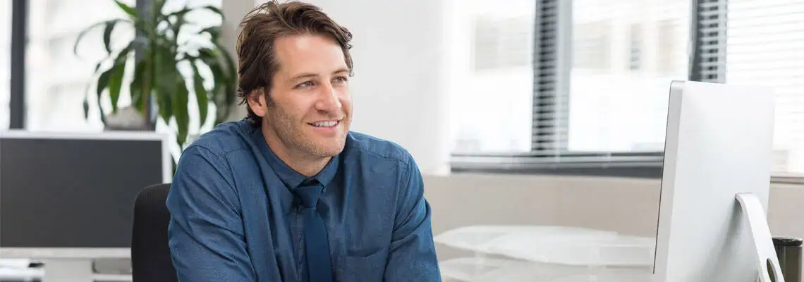 Young,Business,In,Formal,Looking,Away,While,Seated,At,Desk